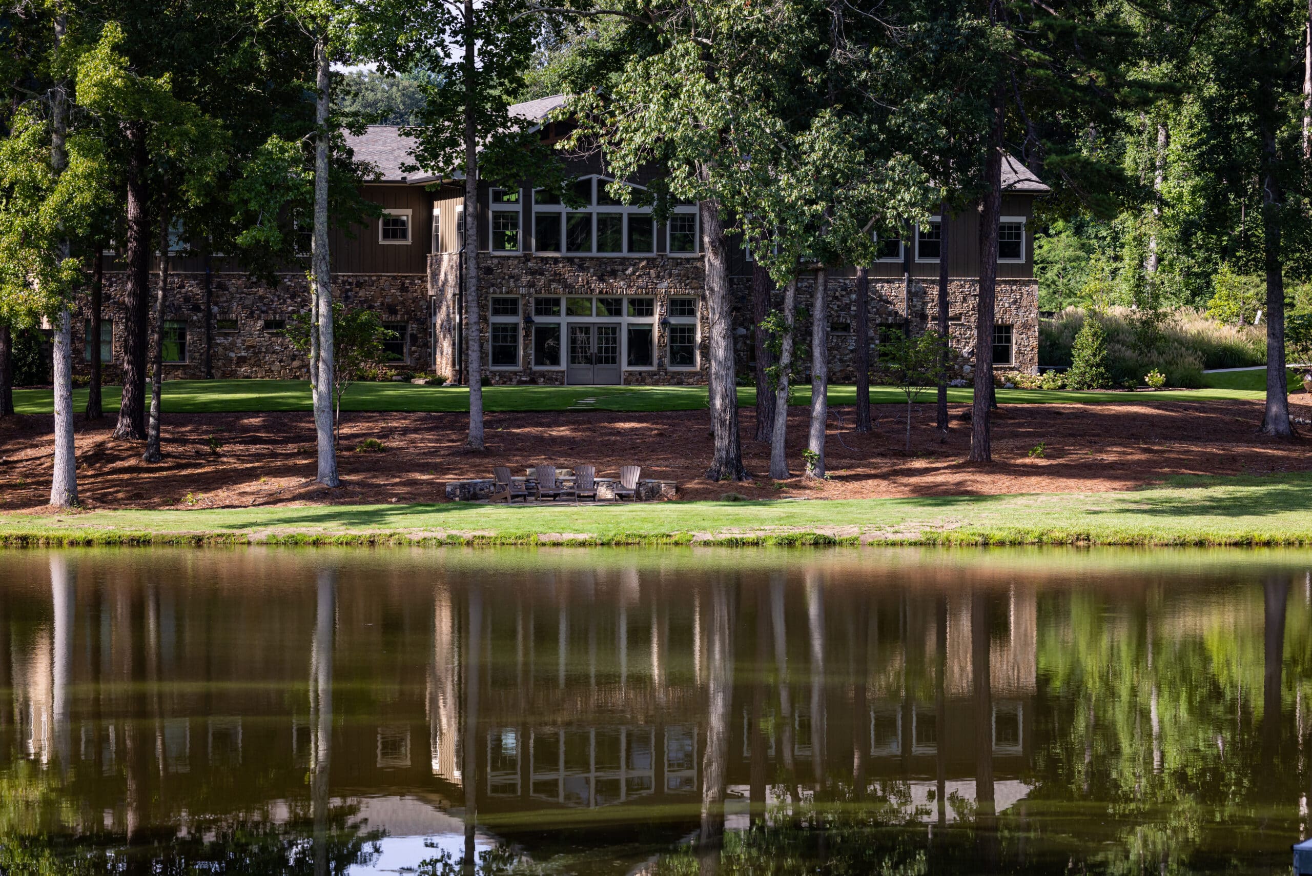 Exterior of Wings Center with lakeside seating area