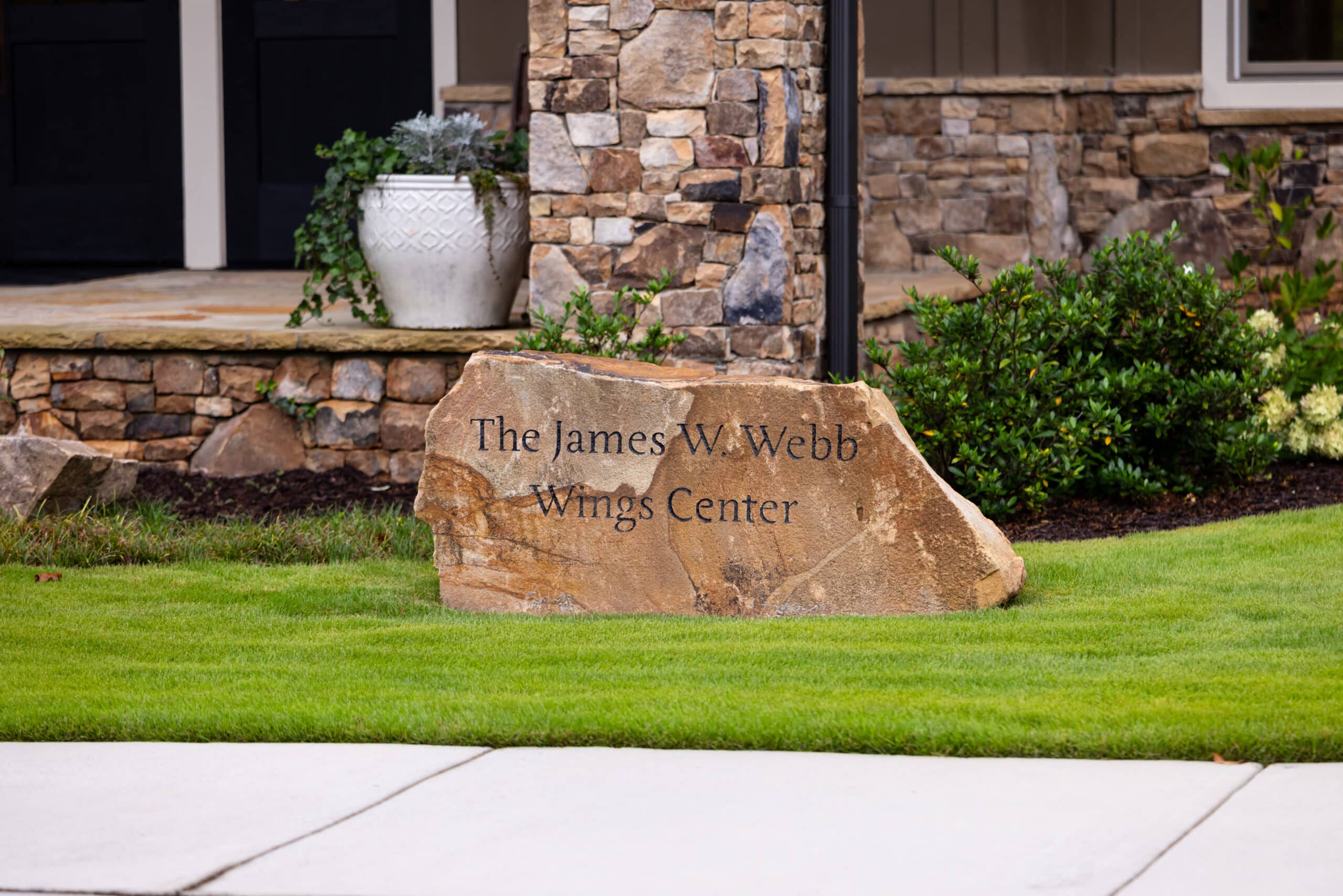 Rock engraved with The James W. Webb Wings Center