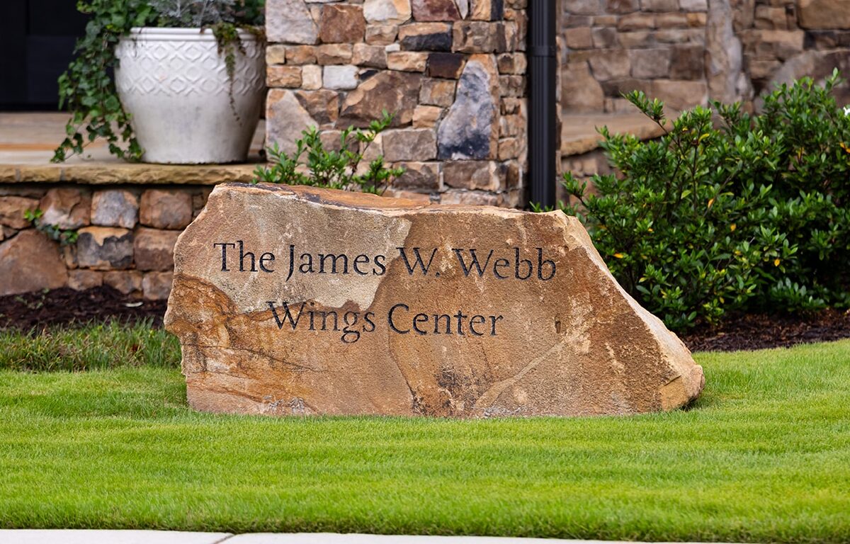 Large architectural decorative stone, engraved with 'The James W. Webb Wings Center'